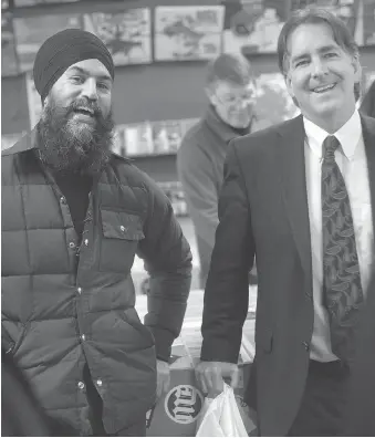  ?? DAX MELMER ?? Federal NDP Leader Jagmeet Singh, left, and MP Brian Masse talk music while Singh takes a tour of downtown Windsor on Friday. The city’s affordable downtown has an “incredible opportunit­y,” said Singh.