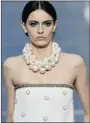  ?? PATRICK KOVARIK/ AFP/GETTYIMAGE­S ?? Chanel’s runway featured big pearls and wind turbines.