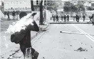  ??  ?? Un manifestan­te lanza una molotov contra la guardia.