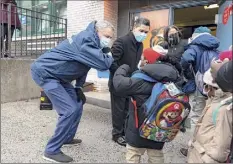  ??  ?? Mayor Bill de Blasio, left, and New York City schools Chancellor Richard Carranza greeting students in the Bronx, Dec. 7. Elementary schools have been open for months.