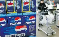  ?? TIM BOYLE/Getty Images ?? Soft drink makers have agreed to reduce the calories in their
beverages by 20 per cent over the next decade.