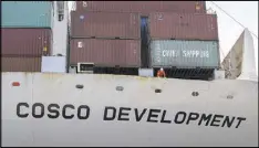  ?? STEPHEN MORTON / GEORGIA PORT AUTHORITY VIA AP ?? A crewman on board the Cosco Developmen­t looks over the side as the vessel docks at the Port of Savannah on Thursday.