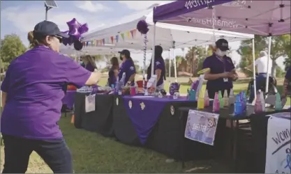  ?? PHOTO COURTESY OF WOMANHAVEN ?? WomanHaven, Inc. volunteers and community members gather together at the inaugural Festival Against Domestic Violence in the theme “Be Purple for the Change,” to raise awareness for domestic violence at Bucklin Park in El Centro, on Saturday, October 23, 2021..