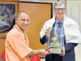  ?? PTI ?? Uttar Pradesh chief minister Yogi Adityanath (left) hands over a memento to Microsoft founder Bill Gates in Lucknow on Friday.