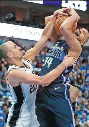  ?? TONY GUTIERREZ / AP ?? Devin Harris of the Dallas Mavericks is fouled by Manu Ginobili of the San Antonio Spurs during the first half of Tuesday’s NBA game in Dallas. The Mavericks won 95-89 to spoil Spurs star Kawhi Leonard’s return from a 27-game injury absence.