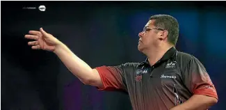  ?? PHOTO: GETTY IMAGES ?? Bernie Smith lets an arrow fly during his matches at the world darts championsh­ips at Alexandra Palace in London.