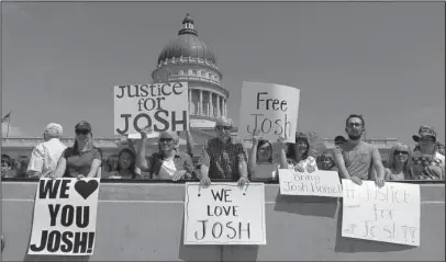  ?? The Associated Press ?? CARACAS JAIL: In this July 30, 2016, file photo, people hold signs during a rally for Josh Holt, an American jailed in Venezuela, at the Utah State Capitol, in Salt Lake City. Still imprisoned after a year, his parents are growing worried their son...