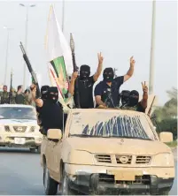  ?? (Alaa Al-Marjani/Reuters) ?? SHI’ITE FIGHTERS from Saraya al-Salam, who are loyal to radical cleric Moqtada al-Sadr, parade with their weapons through Iraq’s holy city of Najaf yesterday.