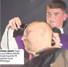  ??  ?? Close shave Pupil Lucas Aitken did the head shave for PE teacher Scott McGregor