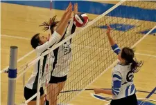  ?? STUART CAHILL / HERALD STAFF ?? STUFFED: Canton’s Liz Bickett and Angie Elias get the block on Carly Goodhue during the Div. 2 state final at Worcester State.