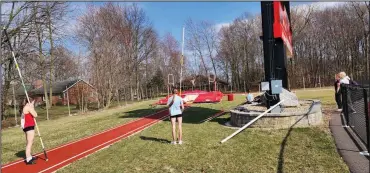  ?? ?? Track team members practice their pole vaulting skills at the Whippets track facility on March 13.
David Jacobs/sdg Newspapers