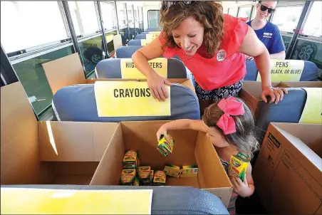  ?? File photo ?? and her daughter Gabrielle Bryant of Springdale sort their donated items for the “Fill The Bus” fundraiser sponsored by the United Way of Northwest Arkansas last year at the Wal-Mart Supercente­r at Pleasant Crossing in Rogers. The items collected help...
