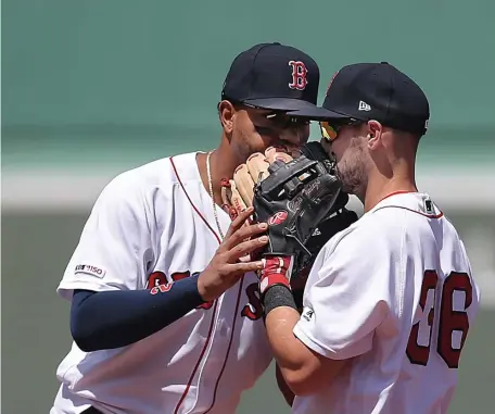  ?? NANCY LANE / BOSTON HERALD ?? LISTEN UP: PawSox callup Chris Owings gets a few words of advice from Xander Bogaerts yesterday.