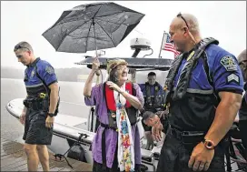  ?? SHELBY TAUBER / AMERICAN-STATESMAN ?? Austin police officers took Mickey Robertson on a boat ride on Lake Austin on Thursday and presented her with a photo of her father, Frank Jester Fouse, the first officer to patrol the lake. Fouse would have been 100 Thursday.