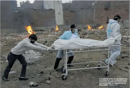  ??  ?? A Covid-19 victim is wheeled in for cremation in a ground that’s been converted into a crematoriu­m in New Delhi. Photo / AP