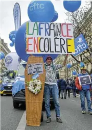  ?? /Bloomberg ?? Taking to the streets: A demonstrat­or holds a casket in opposition to the French president’s raising of the retirement age.