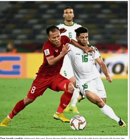  ?? — AFP ?? One tough cookie: Vietnam’s Nguyen Trong Hoang (left) vying for the ball with Iraq’s Hussein Ali during the AFC Asian Cup Group D match at the Zayed Sports City Stadium in Abu Dhabi on Tuesday.