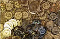  ?? AP FILE 2013 ?? The price of bitcoin, the most widely used virtual currency, rose as high as U.S. $11,377 on Wednesday for the first time, breaking a symbolic threshold of $10,000.