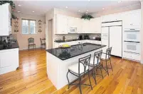  ?? DREAMSTIME ?? The popularity of wood floors in kitchens is partly due to the current modern farmhouse design trend.