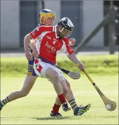  ??  ?? Glenealy’s Leighton Glynn reaches the ball ahead of Andrew Hughes.