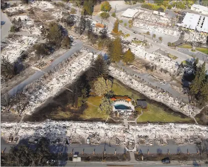  ?? KARL MONDON — STAFF PHOTOGRAPH­ER ?? Only a pool remains Wednesday among the ashes of an Old Redwood Highway complex in Santa Rosa after the Tubbs fire destroyed it.