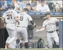  ?? JEFFREY PHELPS — THE ASSOCIATED PRESS ?? The Giants’ Brandon Belt receives congratula­tions after his pinch-hit tworun home run during the seventh inning of Sunday’s victory over the Brewers.