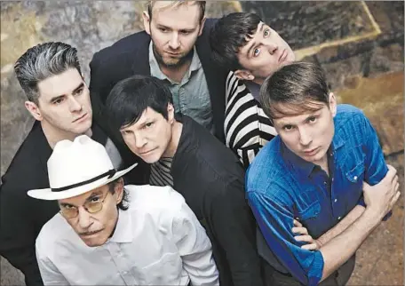  ?? David Edwards
Domino Records ?? THE MEMBERS of the Los Angeles duo Sparks and Scotland’s Franz Ferdinand have a new album: “FFS.” From left are Paul Thomson, Ron Mael (in hat), Russell Mael (center), Bob Hardy (back), Nick McCarthy (striped shirt) and Alex Kapranos (denim).