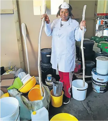  ?? Picture: SIYA TSEWU ?? IN THE MIX: Ncebakazi Sobai holds the wooden sticks she used in the past to mix chemicals when making cleaning products. She now uses machines for the mixing.