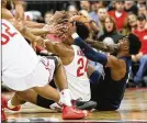  ??  ?? Ohio State’s Andre Wesson (24) battles for a loose ball against Penn State, embodying the fight and force coach Chris Holtmann demands of his team.