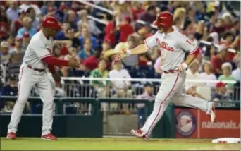  ?? EVAN VUCCI — THE ASSOCIATED PRESS ?? Phillies full-time first baseman Tommy Joseph is congratula­ted by third base coach Juan Samuel, left, after hitting his second home run of the game Friday night amid yet another Phils loss at Nationals Park.