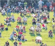  ?? COMPTON / CCOMPTON@AJC.COM CURTIS ?? Fans dot the hillside to watch the first day of team practice at the Falcons training facility Thursday in Flowery Branch.