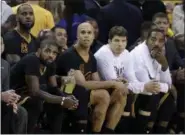  ?? MARCIO JOSE SANCHEZ — ASSOCIATED PRESS ?? From left, Cavaliers' Kyrie Irving, LeBron James, Richard Jefferson, Kyle Korver and J.R. Smith sit on the bench during the second half of Sunday's 132-113 loss to the Warriors in Oakland, Calif.