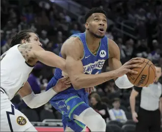  ?? AP photo ?? Milwaukee Bucks’ Giannis Antetokoun­mpo drives past Denver Nuggets’ Aaron Gordon during the second half Monday in Milwaukee.