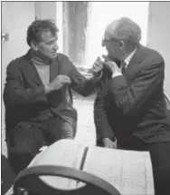  ?? JACOB HARRIS — THE ASSOCIATED PRESS FILE ?? In this file photo conductor Leonard Bernstein, left, and composer Aaron Copland, right, retire to a room backstage during a break in rehearsal to iron out details in the Copland compositio­n “Connotatio­ns for Orchestra,” in New York. Bernstein would...