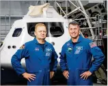  ?? BILL STAFFORD / NASA ?? Astronauts Eric Boe (left) and Robert Shane Kimbrough stand with a mock-up of the Orion spacecraft at NASA’s Johnson Space Center in Houston.