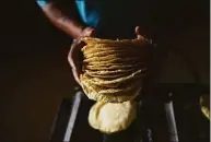  ?? Associated Press ?? A worker packages tortillas to sell for 20 Mexican pesos per kilogram, about one dollar, at a tortilla factory in Mexico City on May 9. Almost a year ago, the same tortilla factory was selling a kilo of tortillas for 10 Mexican pesos.