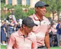  ?? KEVIN KOLCZYNSKI/AP ?? Tiger Woods and his son, Charlie, walk down the fairway of the first hole Saturday during the first round of the PNC Championsh­ip.