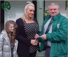  ??  ?? Committee member Garrett O’Reilly and his daughter Caoimhe presenting Elaine Cullen of ‘Aura’ with the award for best shop window display.