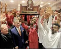  ?? NWA Democrat-Gazette/MICHAEL WOODS ?? Members of Arkansas’ men’s team call the Hogs after winning their 21st SEC indoor track and field championsh­ip on Saturday at the Randal Tyson Track Center in Fayettevil­le. The women’s team won their second consecutiv­e indoor conference title.