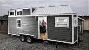  ?? ERIC ALBRECHT / THE COLUMBUS DISPATCH ?? Dan Hamilton shows a model home from his company, Modern Tiny Living.