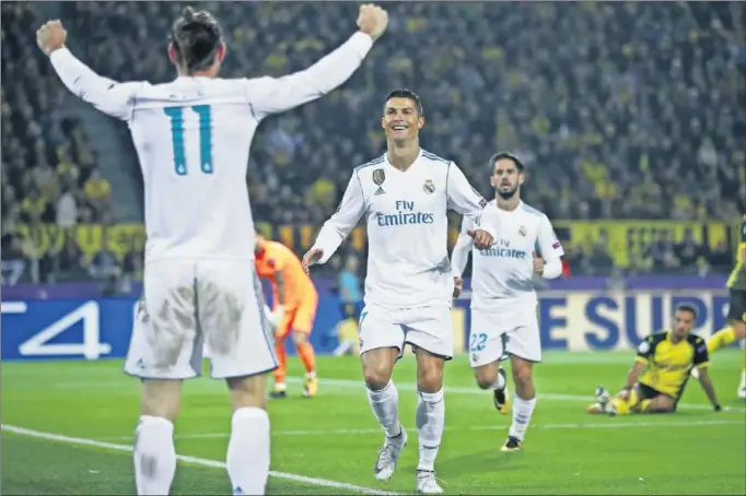  ??  ?? DÚO LETAL. Bale celebra el gol que marcó ayer y que sirvió para abrir el marcador, mientras Cristiano (con Isco al fondo) corre hacia él para felicitarl­e.