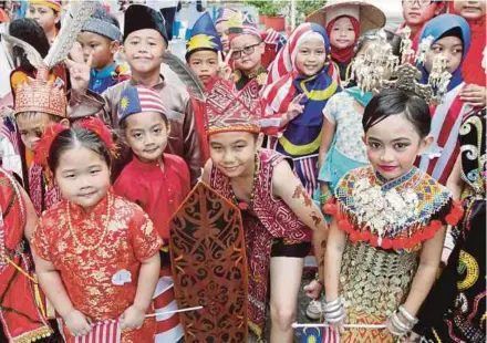  ??  ?? Schoolchil­dren celebratin­g National Day in Kuching. To emphasise commonalit­y implies a quest for tolerance, coexistenc­e and an overcoming of cultural difference­s.