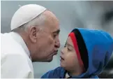  ?? Gabriel Bouys/getty Images ?? Pope Francis kisses a boy as he arrives to celebrate mass at the Basilica of Our Lady of Aparecida.