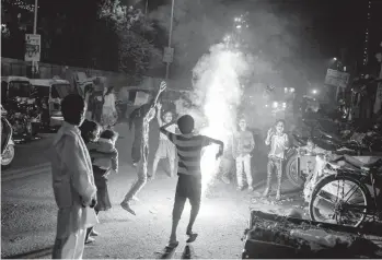  ?? ALTAF QADRI/AP ?? Children play with firecracke­rs Thursday during Diwali celebratio­ns in New Delhi, India. Diwali, the festival of lights, is one of Hinduism’s most important festivals dedicated to the worship of Lakshmi, the Hindu goddess of wealth. Last year, celebratio­ns in India were upended by a renewed spike in COVID-19 infections, but festivitie­s this year seem to be back.