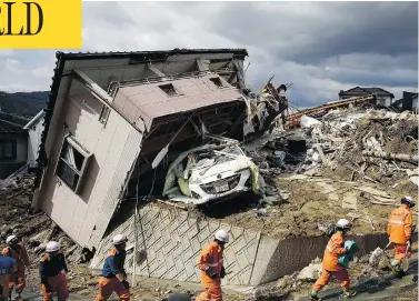  ?? SADAYUKI GOTO/KYODO NEWS VIA THE ASSOCIATED PRESS ?? Rescuers search for missing persons in Kumano town, Hiroshima prefecture, on Monday, after several days of heavy rainfall had set off widespread flooding and landslides across southern and western Japan.