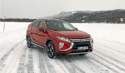  ?? ROB MAETZIG/STUFF ?? Eclipse Cross on the rocks - the AWD version of this new Mitsubishi poses on the ice lake in inland Norway.