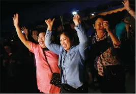  ?? ASSOCIATED PRESS ?? PEOPLES CELEBRATE IN CHIANG RAI AFTER DIVERS EVACUATED the 12 boys and their coach trapped at Tham Luang cave in the Mae Sai district of Chiang Rai province, northern Thailand, on Tuesday. Thai Navy SEALs say all 12 boys and their coach were rescued...