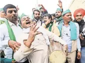  ?? HARISH TYAGI/EPA, VIA SHUTTERSTO­CK ?? Farmers celebrated after Prime Minister Narendra Modi announced that new agricultur­al laws would be repealed.
