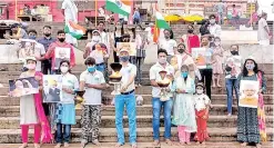  ??  ?? Members of ‘Namami Gange’ programme perform ‘aarti’ on the banks of Ganga river on completion of 7 years of Modi-led BJP government, in Varanasi