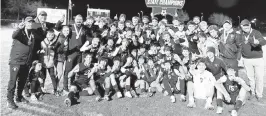  ?? BILL KEMP Special to the Miami Herald ?? Gulliver Prep players and coaches celebrate with the state championsh­ip trophy after winning the Class 4A boys’ soccer title Saturday at Lake Myrtle Park in Auburndale.